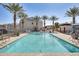 Resort-style pool with clear blue water, palm trees, and comfortable lounge chairs for relaxing and enjoying the sun at 2228 W Harmont Dr, Phoenix, AZ 85021