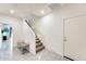 Bright entry hallway with tiled flooring, a carpeted staircase, and access to other rooms at 2228 W Harmont Dr, Phoenix, AZ 85021