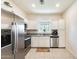 Well-lit kitchen features stainless steel appliances, white cabinets, and granite countertops at 2228 W Harmont Dr, Phoenix, AZ 85021