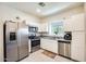 Well-lit kitchen features stainless steel appliances and white cabinets and granite countertops at 2228 W Harmont Dr, Phoenix, AZ 85021