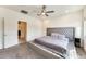 The spacious main bedroom includes an ensuite bathroom and comfortable carpeting at 2228 W Harmont Dr, Phoenix, AZ 85021