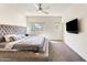 Luxurious main bedroom with a tufted headboard, comfortable carpet, and natural light from two windows at 2228 W Harmont Dr, Phoenix, AZ 85021