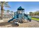 Fun playground featuring a slide, climbing structures and a swing set on a sunny day at 2228 W Harmont Dr, Phoenix, AZ 85021