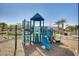 Community playground equipment with a slide and other activity areas, surrounded by mature palm trees at 2228 W Harmont Dr, Phoenix, AZ 85021