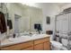 Bathroom with double sinks, a large mirror, and decorative shower curtain at 2373 N Riverside Dr, Florence, AZ 85132