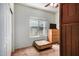 Well-lit bedroom with a window, dresser, small table, and light-colored carpet at 2373 N Riverside Dr, Florence, AZ 85132