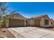 Stunning home exterior featuring a three car garage and a beautiful terra cotta tile roof at 2373 N Riverside Dr, Florence, AZ 85132