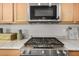 Close up of a well-equipped kitchen with stainless steel appliances and white countertops at 2373 N Riverside Dr, Florence, AZ 85132