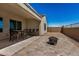 Outdoor patio area with a dining table, chairs, and a fire pit for relaxing evenings at 2373 N Riverside Dr, Florence, AZ 85132