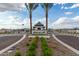 Grove at Lehi community entrance with palm trees and the American flag on a bright, sunny day at 2461 E Presidio St, Mesa, AZ 85213