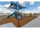 Colorful community playground featuring a slide and shade canopy on a wood chip surface at 2461 E Presidio St, Mesa, AZ 85213