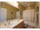 Bright bathroom with double sinks, large mirror, and a shower-tub combination with curtain at 2509 E Dulcinea Trl, Casa Grande, AZ 85194