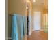 This bathroom features blue towels, tile flooring, and a door leading to the walk-in closet at 2509 E Dulcinea Trl, Casa Grande, AZ 85194