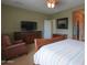 Relaxing bedroom area featuring a bed, chair, and television for relaxation at 2509 E Dulcinea Trl, Casa Grande, AZ 85194