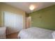 A bright bedroom with an accent wall, neutral carpet, and a view of the bedroom closet at 2509 E Dulcinea Trl, Casa Grande, AZ 85194