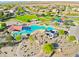 A beautiful community pool with winding slides, splash pads, covered seating, and recreational areas at 2509 E Dulcinea Trl, Casa Grande, AZ 85194