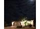 An inviting single-story home at night, highlighted by exterior lighting and a meticulously landscaped front yard at 2509 E Dulcinea Trl, Casa Grande, AZ 85194