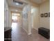 Hallway leading into a living room with beautiful tiled floors, neutral walls, and ample lighting at 2509 E Dulcinea Trl, Casa Grande, AZ 85194