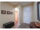 Neutral hallway featuring tile floors, a decorative bench, and framed wall art at 2509 E Dulcinea Trl, Casa Grande, AZ 85194