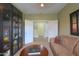 Cozy living room space with sofa, coffee table, and floor to ceiling shelving at 2509 E Dulcinea Trl, Casa Grande, AZ 85194