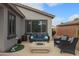 Inviting covered patio with comfortable seating and a modern fire pit, perfect for outdoor relaxation at 2509 E Dulcinea Trl, Casa Grande, AZ 85194