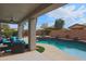 Covered patio offers a perfect view of the sparkling pool and backyard at 2509 E Dulcinea Trl, Casa Grande, AZ 85194