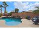 Lush backyard oasis featuring a custom pool, spa, and tranquil seating area at 2509 E Dulcinea Trl, Casa Grande, AZ 85194