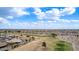 Aerial shot of homes alongside a golf course under a blue sky with clouds, showcasing the community's peaceful setting at 2712 S Tambor --, Mesa, AZ 85209