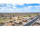 Panoramic aerial view of the community showcasing the golf course, homes, and desert surroundings under a blue sky at 2712 S Tambor --, Mesa, AZ 85209