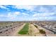 Wide aerial shot of homes and a golf course within the community, set against a backdrop of desert terrain at 2712 S Tambor --, Mesa, AZ 85209