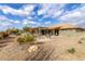 Beautiful backyard with a covered patio, seating area, rock landscaping, and lush greenery at 2712 S Tambor --, Mesa, AZ 85209