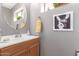 Charming powder room featuring a vanity, decorative mirror, and cute wall art at 2712 S Tambor --, Mesa, AZ 85209