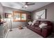 Cozy bedroom featuring a ceiling fan, shuttered windows, and comfortable seating area at 2712 S Tambor --, Mesa, AZ 85209