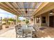 Inviting covered patio featuring a dining table, grill, fan, and decorative lighting, great for outdoor entertaining at 2712 S Tambor --, Mesa, AZ 85209