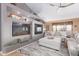 Bright living room featuring a modern fireplace, built-in shelves, and comfortable seating at 2712 S Tambor --, Mesa, AZ 85209