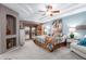 Comfortable main bedroom featuring trey ceilings, a ceiling fan, and southwestern-inspired decor at 2712 S Tambor --, Mesa, AZ 85209