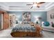 Inviting main bedroom with beamed ceiling, fan, southwestern decor, and private entry at 2712 S Tambor --, Mesa, AZ 85209