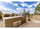 Built-in outdoor kitchen featuring a modern grill, stainless steel storage, and a stone countertop at 2712 S Tambor --, Mesa, AZ 85209