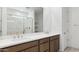 Bathroom vanity featuring double sinks, quartz countertop, and a large mirror at 27280 N 74Th Ln, Peoria, AZ 85383