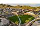 A birds eye view of the community park featuring a large green lawn, walking path, and native desert trees at 27280 N 74Th Ln, Peoria, AZ 85383