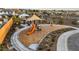 Community playground featuring a slide, shade structure, benches, and walking path at 27280 N 74Th Ln, Peoria, AZ 85383