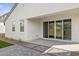 A covered back patio with access to the house via sliding glass doors and stone pavers at 27288 N 74Th Ln, Peoria, AZ 85383