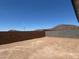 Large, flat backyard enclosed by walls, ready for landscaping or outdoor living spaces at 27288 N 74Th Ln, Peoria, AZ 85383