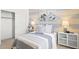 Bedroom with gray and white striped walls, side tables, and view of a closet at 27288 N 74Th Ln, Peoria, AZ 85383