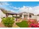 A covered grill area highlights this back yard with lovely desert landscaping and a white block wall at 28617 N 50Th Pl, Cave Creek, AZ 85331