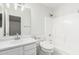 Clean bathroom featuring a sink, toilet, and shower with bright white tile at 28617 N 50Th Pl, Cave Creek, AZ 85331