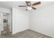 This bedroom features neutral carpeting, a ceiling fan, and a closet at 28617 N 50Th Pl, Cave Creek, AZ 85331