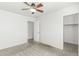 Bright bedroom featuring neutral carpeting, a ceiling fan, and a closet at 28617 N 50Th Pl, Cave Creek, AZ 85331