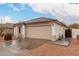 Charming single-story home with a tile roof, neutral stucco, and a two-car garage, set against a partly cloudy sky at 28617 N 50Th Pl, Cave Creek, AZ 85331