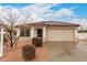 Charming single-story home with a tile roof, neutral stucco, and a two-car garage, set against a partly cloudy sky at 28617 N 50Th Pl, Cave Creek, AZ 85331